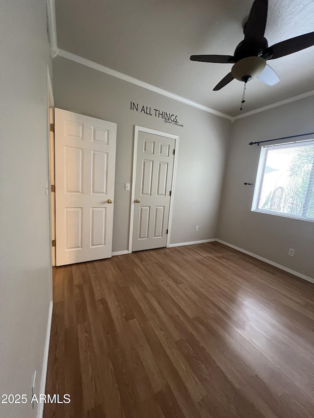 unfurnished bedroom featuring ceiling fan, wood-type flooring, and ornamental molding