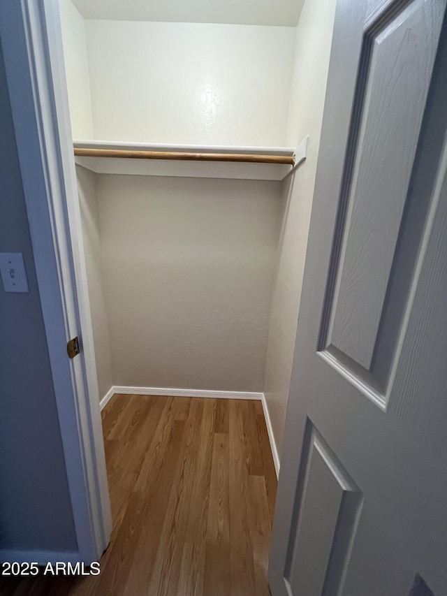 spacious closet featuring hardwood / wood-style floors