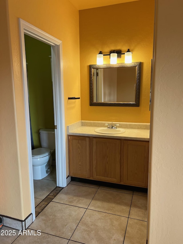 bathroom with tile patterned floors, vanity, and toilet