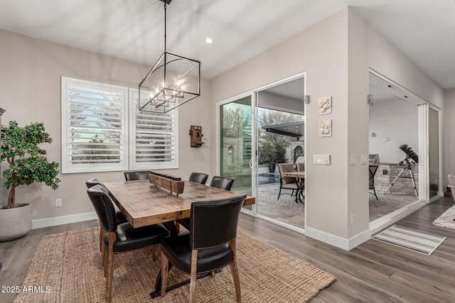 dining space featuring an inviting chandelier and hardwood / wood-style floors