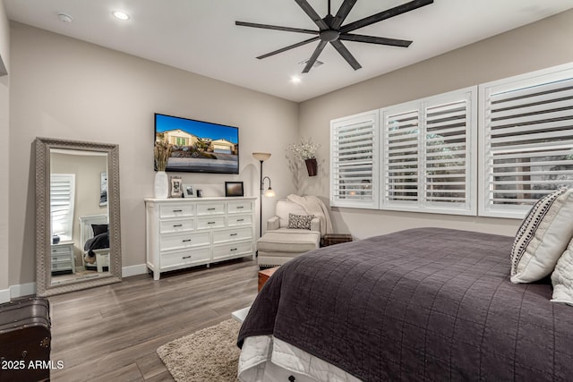 bedroom with ceiling fan and hardwood / wood-style floors