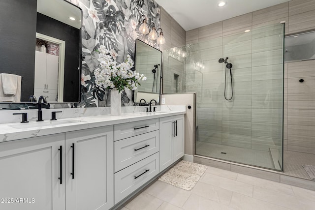 bathroom featuring tile patterned floors, tiled shower, and vanity