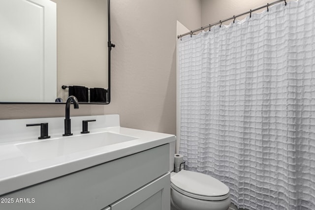 bathroom with toilet and vanity