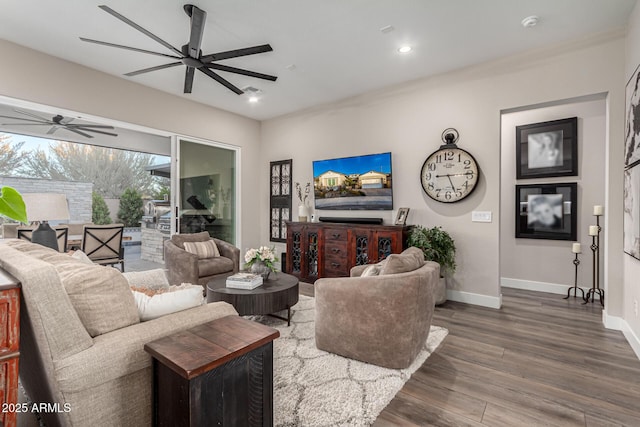 living room with ceiling fan and hardwood / wood-style flooring