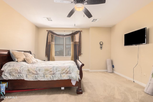 bedroom with ceiling fan and light carpet