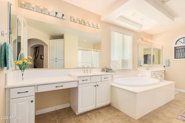 bathroom featuring a bathing tub, vanity, and tile patterned flooring