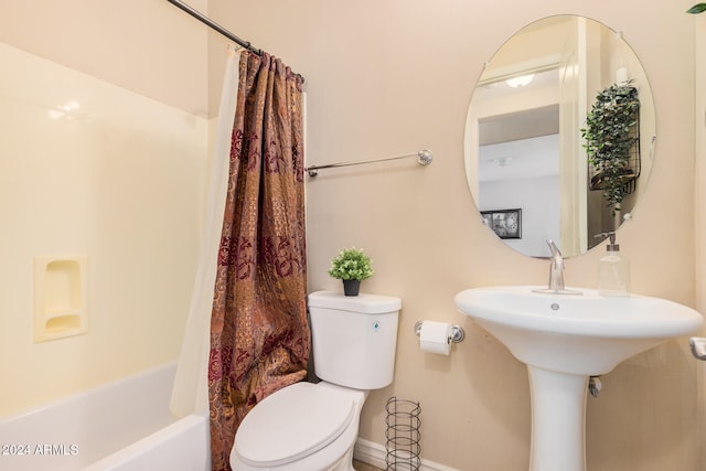 bathroom with shower / bath combination with curtain and toilet