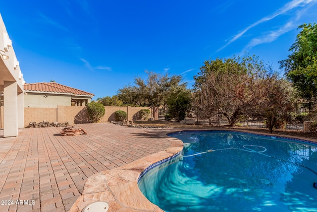 view of swimming pool with a patio area