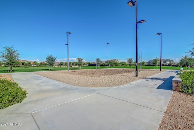 surrounding community featuring a yard and volleyball court