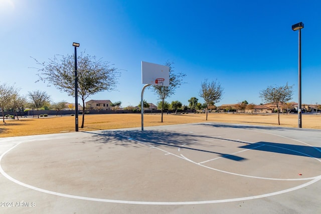 view of basketball court featuring a yard