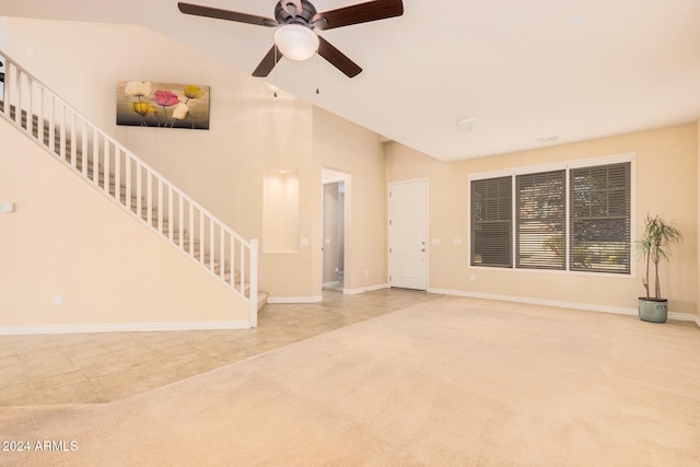 unfurnished living room with light carpet, ceiling fan, and vaulted ceiling