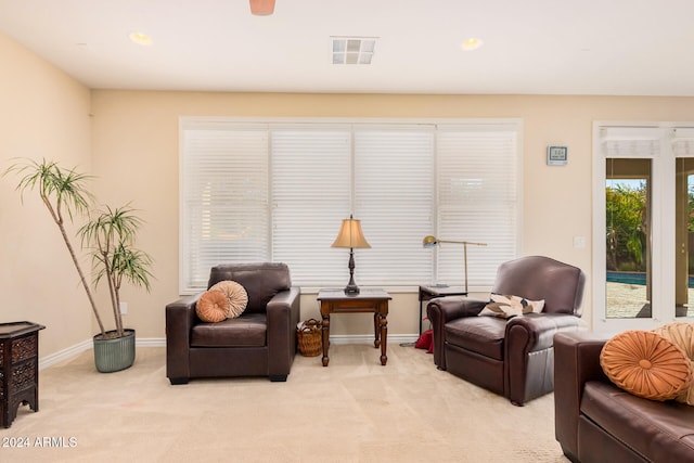 sitting room with light colored carpet