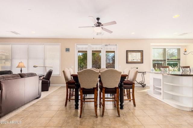 tiled dining area with ceiling fan