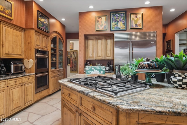 kitchen with stainless steel appliances, recessed lighting, stone countertops, stone finish flooring, and a kitchen island