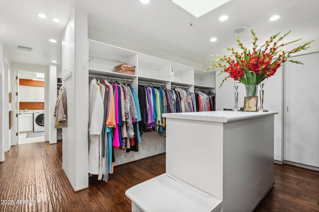 walk in closet featuring washer / dryer, visible vents, a skylight, and wood finished floors