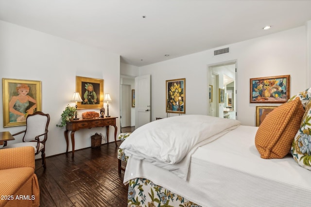 bedroom featuring recessed lighting, visible vents, ensuite bath, and hardwood / wood-style flooring