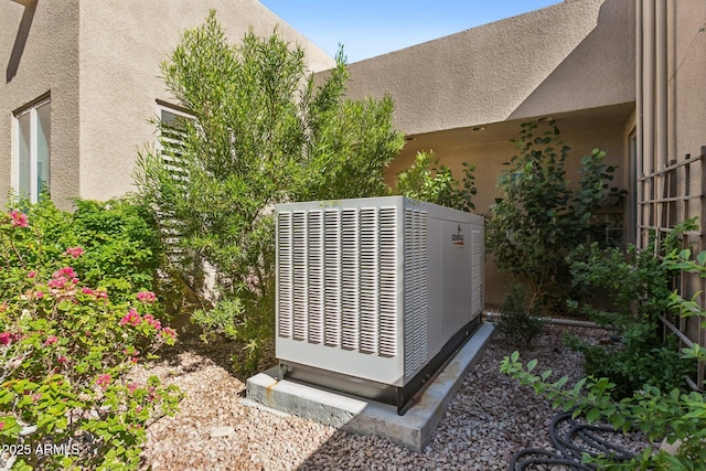 exterior details featuring central air condition unit and stucco siding