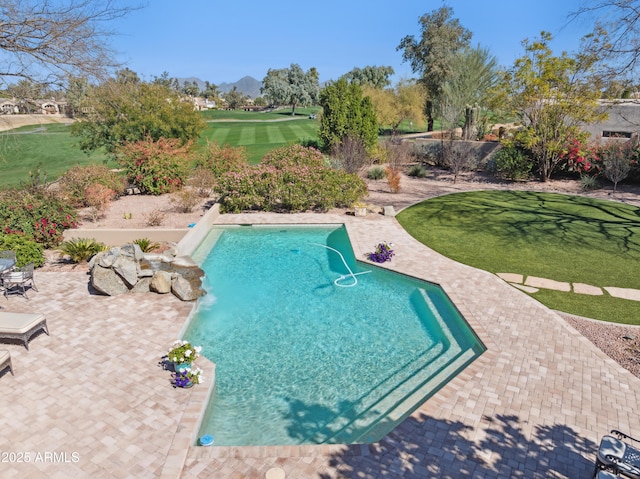 view of pool with a yard, a patio, and a mountain view