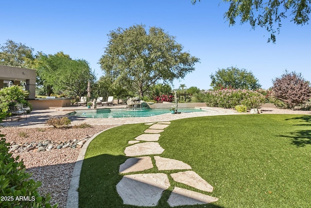 view of yard featuring a patio area and an outdoor pool