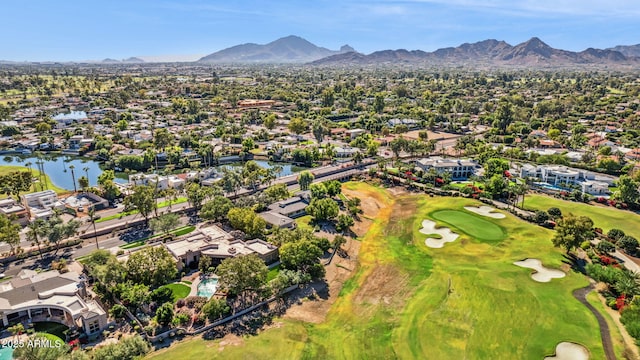 birds eye view of property with view of golf course, a residential view, and a water and mountain view