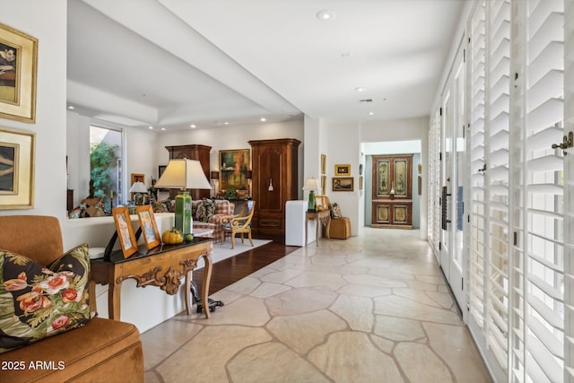 entrance foyer with stone finish flooring and recessed lighting