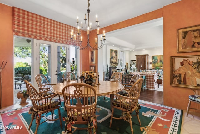 dining room with an inviting chandelier, wood finished floors, and french doors