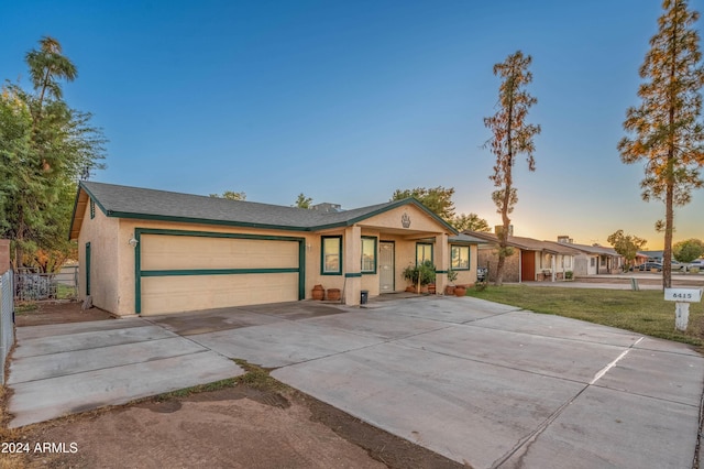 6415 W Roosevelt St, Phoenix, AZ 85043 - single story home featuring stucco siding, an attached garage, driveway, and a yard