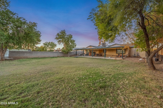 6415 W Roosevelt St, Phoenix, AZ 85043 - yard at dusk featuring a patio area