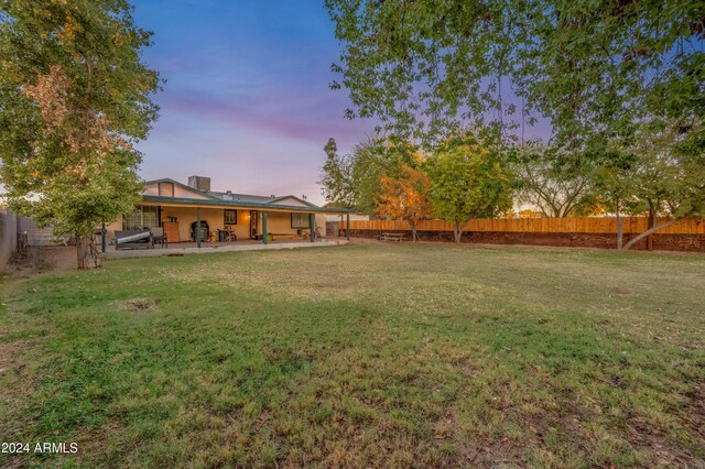 6415 W Roosevelt St, Phoenix, AZ 85043 - yard at dusk with a patio area