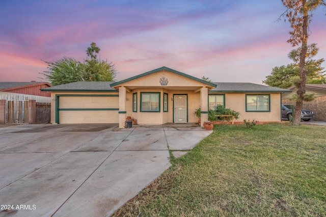 6415 W Roosevelt St, Phoenix, AZ 85043 - ranch-style home with driveway, an attached garage, and stucco siding