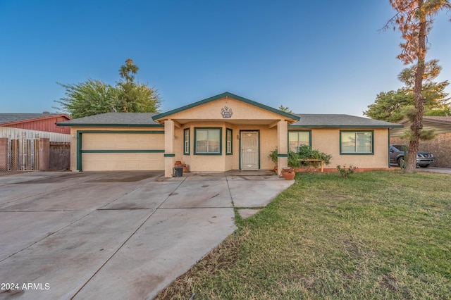 6415 W Roosevelt St, Phoenix, AZ 85043 - ranch-style house featuring an attached garage, driveway, and stucco siding