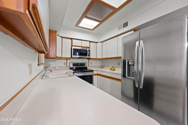 6415 W Roosevelt St, Phoenix, AZ 85043 - kitchen with stainless steel appliances, a sink, light countertops, and white cabinetry