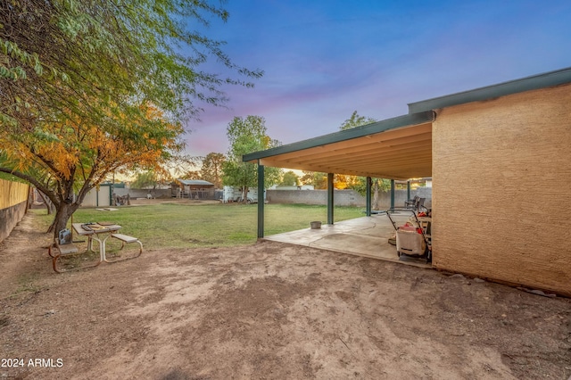 6415 W Roosevelt St, Phoenix, AZ 85043 - yard at dusk with a patio