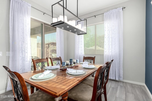 dining room featuring plenty of natural light and baseboards