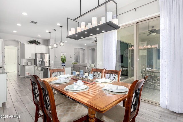 dining room with recessed lighting, arched walkways, and ceiling fan