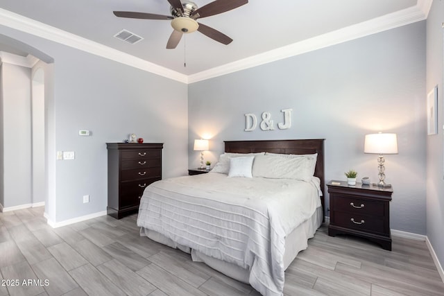 bedroom featuring visible vents, crown molding, baseboards, wood tiled floor, and arched walkways