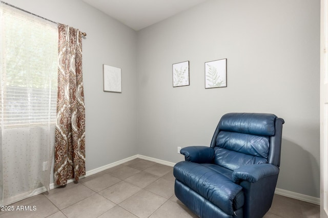 sitting room featuring light tile patterned floors and baseboards