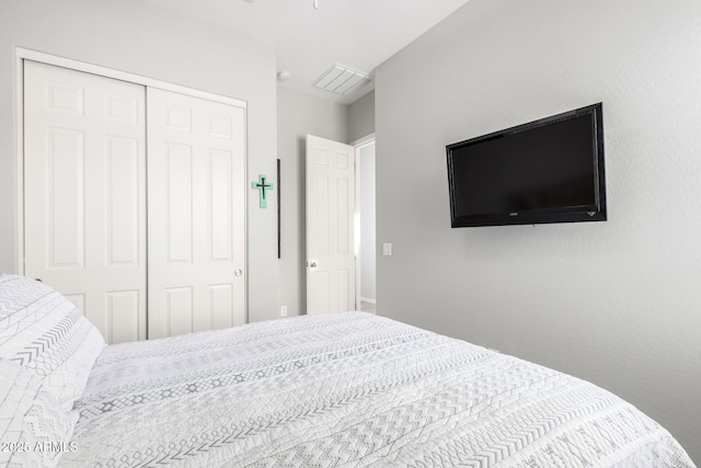 bedroom with a closet and visible vents