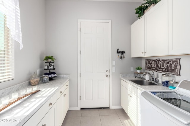 kitchen featuring light tile patterned floors, a sink, stove, white cabinets, and light countertops