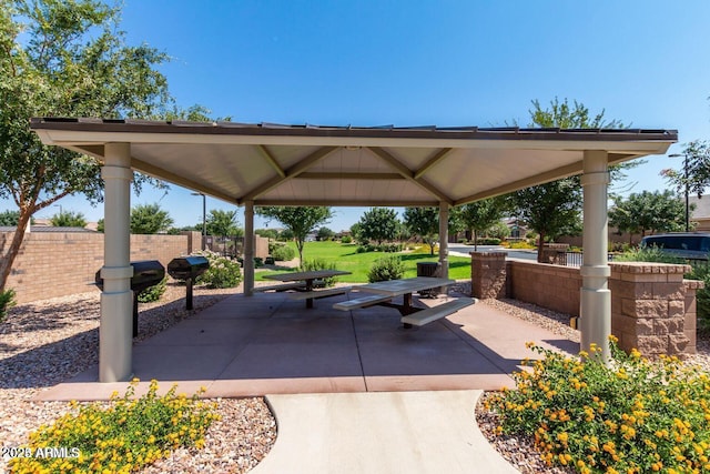 view of home's community featuring a gazebo, a patio area, a yard, and fence