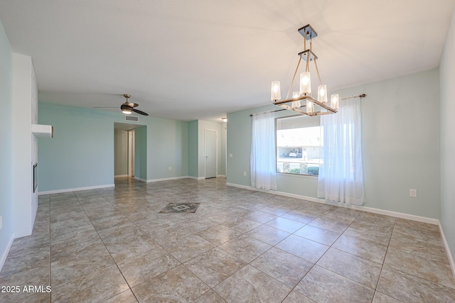 tiled empty room featuring ceiling fan with notable chandelier