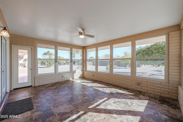 unfurnished sunroom with ceiling fan and plenty of natural light