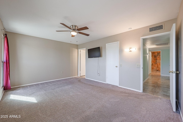 unfurnished bedroom featuring light colored carpet and ceiling fan