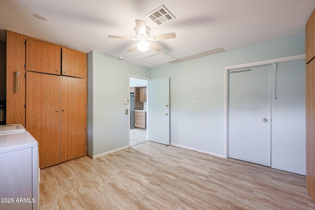 unfurnished bedroom featuring separate washer and dryer and ceiling fan