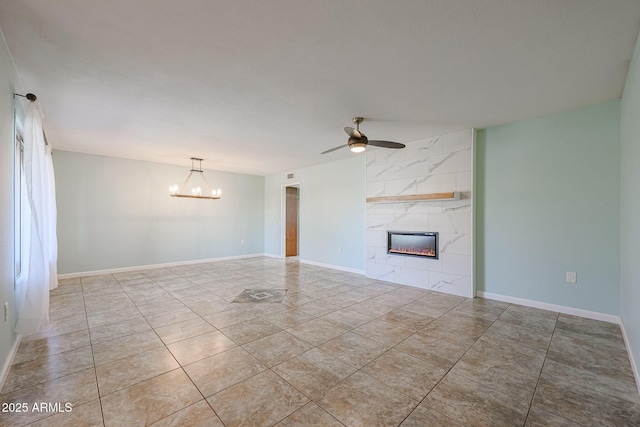 unfurnished living room featuring a tile fireplace, light tile patterned floors, and ceiling fan with notable chandelier