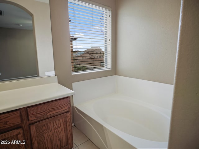 full bathroom featuring a bath, tile patterned floors, and vanity