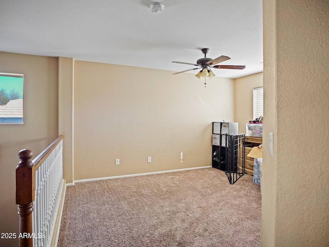 office featuring baseboards, ceiling fan, and carpet floors