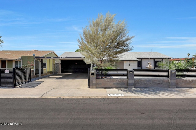 8202 W Turney Ave, Phoenix, AZ 85033 - view of front of house featuring a fenced front yard, driveway, a garage, and stucco siding