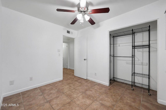 8202 W Turney Ave, Phoenix, AZ 85033 - unfurnished bedroom featuring light tile patterned flooring, ceiling fan, and a closet