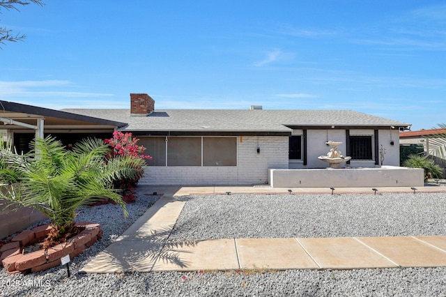 8202 W Turney Ave, Phoenix, AZ 85033 - ranch-style home featuring a chimney, a shingled roof, and brick siding